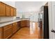 Modern kitchen featuring stainless steel appliances, wood cabinets and hardwood floors, with access to the living room at 392 Beranda Cir, Douglasville, GA 30134
