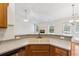 Kitchen with countertop bar seating, dual sink and stainless steel dishwasher with views of the fireplace in the living room at 392 Beranda Cir, Douglasville, GA 30134