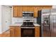 Kitchen showcasing stainless steel appliances, wooden cabinets, and plenty of counter space at 392 Beranda Cir, Douglasville, GA 30134