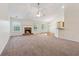 Spacious living room features a fireplace, ceiling fan, neutral carpeting and access to the back patio at 392 Beranda Cir, Douglasville, GA 30134