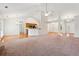 Open concept living room showcasing carpeted space and hardwood floors leading into the dining and kitchen areas at 392 Beranda Cir, Douglasville, GA 30134