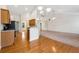 Open floor plan showcasing living room with hardwood floors, kitchen with bar seating and adjoining carpeted area at 392 Beranda Cir, Douglasville, GA 30134