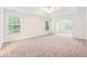 Spacious main bedroom with plush carpeting, tray ceiling and large windows offering natural light at 392 Beranda Cir, Douglasville, GA 30134