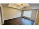 Bright and airy bedroom showcasing ceiling fan, tray ceilings, and large window filling the space with natural light at 4134 Rogers Creek Ct # 41, Duluth, GA 30096