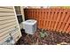 View of the home's modern HVAC system located outside with a wood privacy fence and meticulous mulch ground covering at 4134 Rogers Creek Ct # 41, Duluth, GA 30096