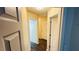 Hallway showcasing hardwood flooring, fresh paint, and ample natural light at 4134 Rogers Creek Ct # 41, Duluth, GA 30096