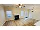 Bright living room featuring a fireplace, hardwood floors, and windows overlooking the backyard at 4134 Rogers Creek Ct # 41, Duluth, GA 30096