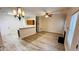 Open-concept living space with a fireplace, hardwood floors, and access to the kitchen at 4134 Rogers Creek Ct # 41, Duluth, GA 30096