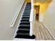 The staircase features a white handrail and black steps, seamlessly connecting different levels of the home at 4134 Rogers Creek Ct # 41, Duluth, GA 30096