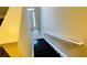 Image highlighting a stairway that has wooden steps, white walls, and a matching white handrail for safety and style at 4134 Rogers Creek Ct # 41, Duluth, GA 30096