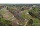 Aerial view showcasing the golf course with mature trees and lush green fairways at 55 Hazelbrook Way, Acworth, GA 30101