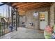 Covered back patio featuring brickwork and access to upper-level stairs, perfect for outdoor dining and relaxation at 55 Hazelbrook Way, Acworth, GA 30101