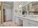 Bathroom boasts double sinks, marble countertops, decorative mirrors, and tile floors at 55 Hazelbrook Way, Acworth, GA 30101