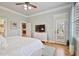 Bedroom features a ceiling fan, hardwood floors, TV, and French doors at 55 Hazelbrook Way, Acworth, GA 30101