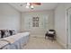 Bright bedroom features carpet and neutral walls with decorative chair and ceiling fan at 55 Hazelbrook Way, Acworth, GA 30101