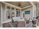 Inviting covered porch with comfortable seating and a mounted TV, ideal for outdoor entertainment and relaxation at 55 Hazelbrook Way, Acworth, GA 30101