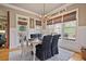 Cozy dining area with large windows, a chandelier, and comfortable seating at 55 Hazelbrook Way, Acworth, GA 30101