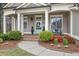 Welcoming front porch with lush landscaping, a seating area and decorative details at 55 Hazelbrook Way, Acworth, GA 30101