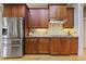 Spacious kitchen features stainless steel appliances, wood cabinetry, and granite countertops at 55 Hazelbrook Way, Acworth, GA 30101