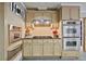 Kitchen with stainless steel double ovens, tan cabinets, and tile backsplash at 55 Hazelbrook Way, Acworth, GA 30101