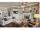 Comfortable living room with a fireplace, built-in shelves, and stylish furnishings at 55 Hazelbrook Way, Acworth, GA 30101
