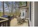 Outdoor patio with seating, a grill, and serene wooded views, perfect for enjoying meals and outdoor gatherings at 55 Hazelbrook Way, Acworth, GA 30101