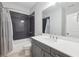 Modern bathroom features a vanity with gray cabinets and a white countertop with a shower and bathtub combination at 115 Harlow Cir, Roswell, GA 30076