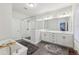 Bright bathroom featuring a modern vanity, a soaking tub, and a glass-enclosed shower at 115 Harlow Cir, Roswell, GA 30076