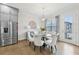 Cozy dining area with stainless steel refrigerator, seating for six, and hardwood flooring at 115 Harlow Cir, Roswell, GA 30076