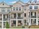 Beautiful townhome featuring brick facade, double balconies, and well-maintained landscaping at 115 Harlow Cir, Roswell, GA 30076