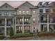 Charming three-story townhome with brick facade and private balcony on first and second floor at 115 Harlow Cir, Roswell, GA 30076
