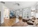Sunlit living space featuring hardwood floors, plush seating, and multiple windows creating an inviting atmosphere at 115 Harlow Cir, Roswell, GA 30076