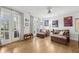 A cozy living area is furnished with plush armchairs, complemented by hardwood floors and multiple windows at 115 Harlow Cir, Roswell, GA 30076