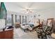 Spacious main bedroom with large windows, ceiling fan, and seating area at 115 Harlow Cir, Roswell, GA 30076
