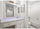 Bathroom featuring a tub with shower, a vanity and updated fixtures at 1606 Vicksburg Pl, Atlanta, GA 30350