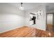 Dining room with wood floors, an open doorway to the kitchen, and modern pendant lighting at 1606 Vicksburg Pl, Atlanta, GA 30350