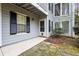 Exterior of home featuring light-grey siding, black shutters, and a walkway leading to the front door at 1606 Vicksburg Pl, Atlanta, GA 30350
