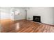 Living room featuring wood floors, a fireplace, and an open layout at 1606 Vicksburg Pl, Atlanta, GA 30350