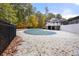 Backyard with a covered outdoor pool and deck in a private, wooded setting at 1606 Vicksburg Pl, Atlanta, GA 30350