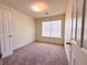 Cozy bedroom featuring soft carpet, a window with blinds, and a simple, clean design at 290 Brookview Dr, Riverdale, GA 30274