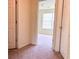 Hallway view showcasing access to a sunlit room with a window, enhancing the sense of space at 290 Brookview Dr, Riverdale, GA 30274