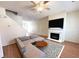 Bright living room features a fireplace, ceiling fan, and a sectional sofa with hardwood floors at 290 Brookview Dr, Riverdale, GA 30274