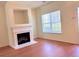 Living room view showcasing the fireplace, large window, and hardwood floors at 290 Brookview Dr, Riverdale, GA 30274