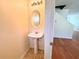 Cozy powder room featuring a pedestal sink and decorative mirror at 290 Brookview Dr, Riverdale, GA 30274