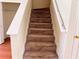 Carpeted staircase with white railing, leading to the upper level, and provides seamless transition at 290 Brookview Dr, Riverdale, GA 30274