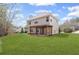 Exterior shot of a well-maintained lawn with a covered patio and view of the second story at 453 Clematis Ct, Temple, GA 30179