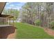 Expansive backyard featuring a shed with a backdrop of mature trees, complemented by a stone border at 453 Clematis Ct, Temple, GA 30179