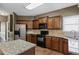 Bright kitchen with modern stainless steel appliances, granite countertops, and wood cabinets at 453 Clematis Ct, Temple, GA 30179