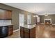 Open-concept living room featuring hardwood floors, fireplace, and a kitchen island at 453 Clematis Ct, Temple, GA 30179