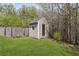 View of the backyard shed with a small window, steps, and a glass paned door at 453 Clematis Ct, Temple, GA 30179